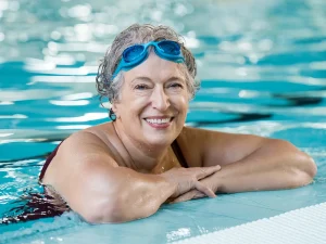 Senior woman wearing goggles in swimming pool